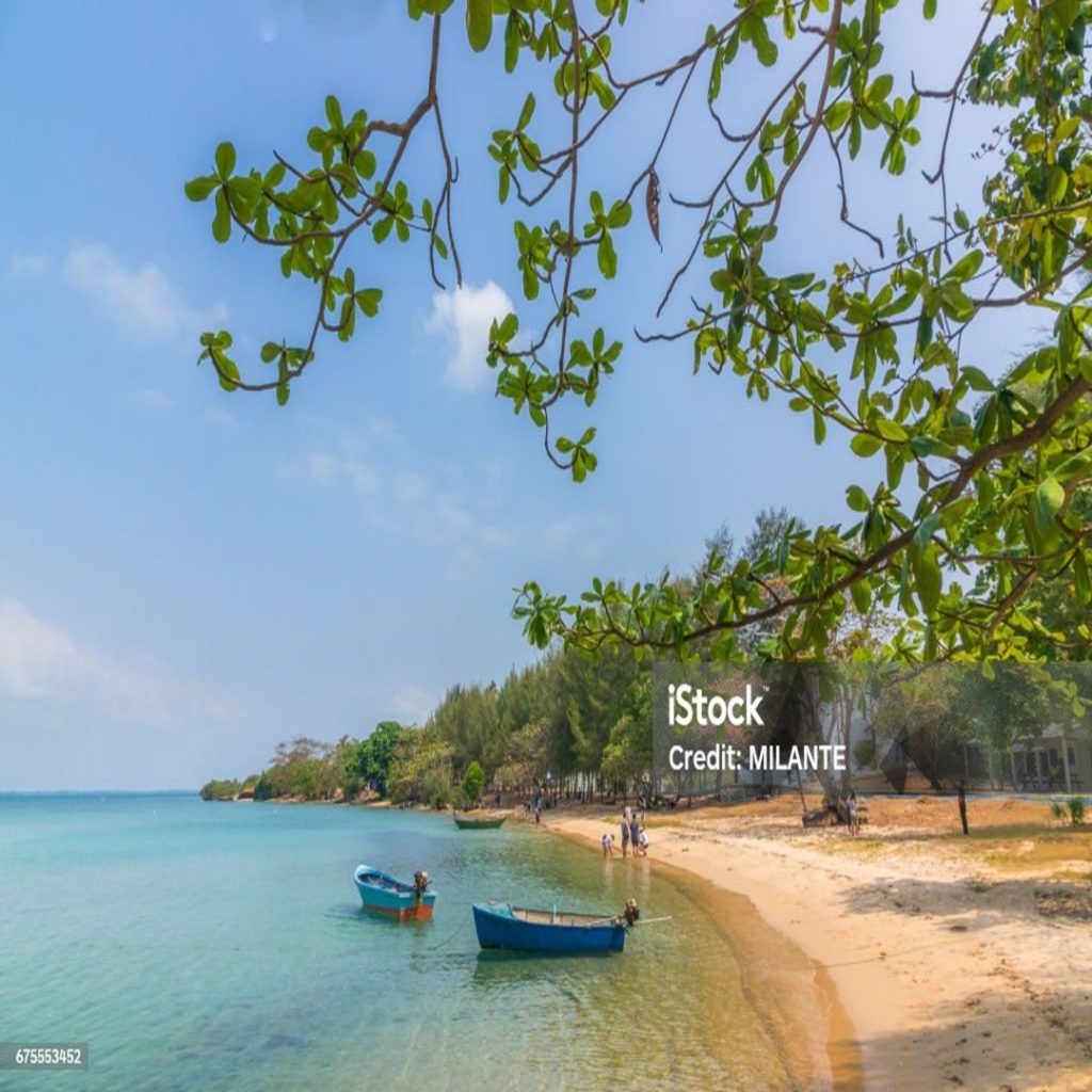 Seaside beach view with fisher boat see through the water to sebase
